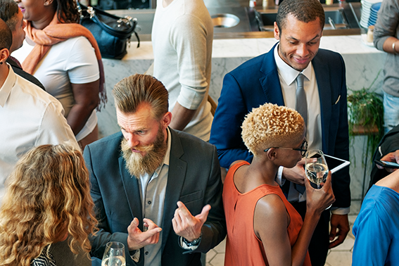 A diverse group of professionals engaging in conversation at a networking event.